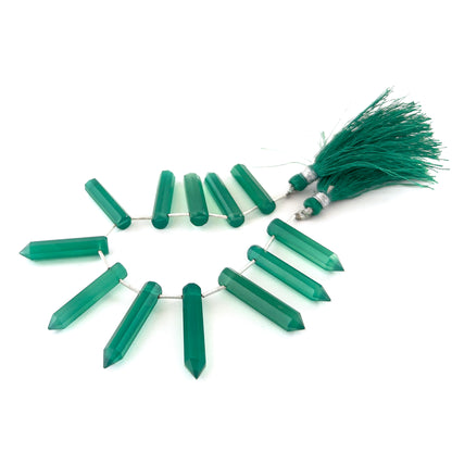 Close‑up of Green Onyx faceted pencil briolette beads highlighting their reflective facets and vibrant green hue.