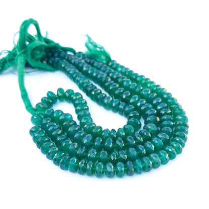 Green onyx faceted rondelle beads in 9.5–10mm size arranged in a strand for handmade jewellery components.