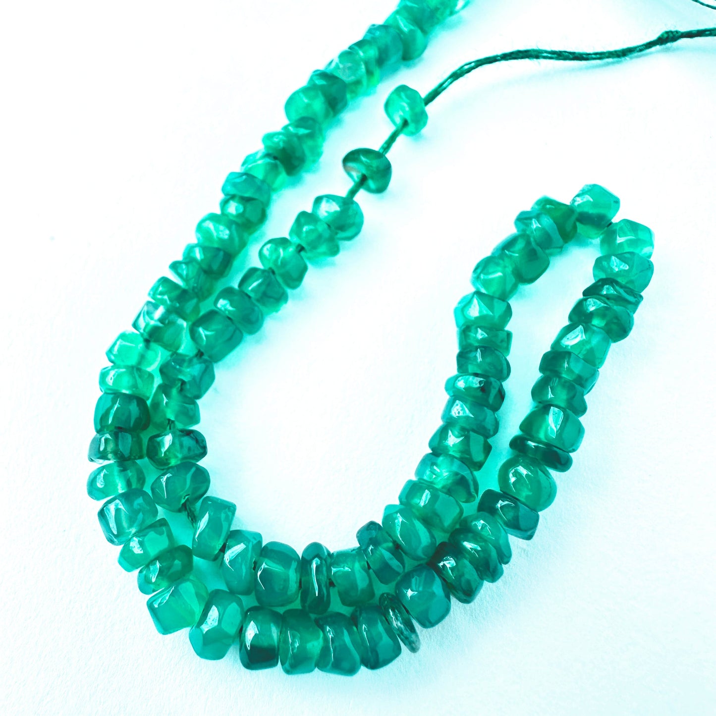 Close-up of Onyx stone beads showing smooth cut and natural gemstone shine.