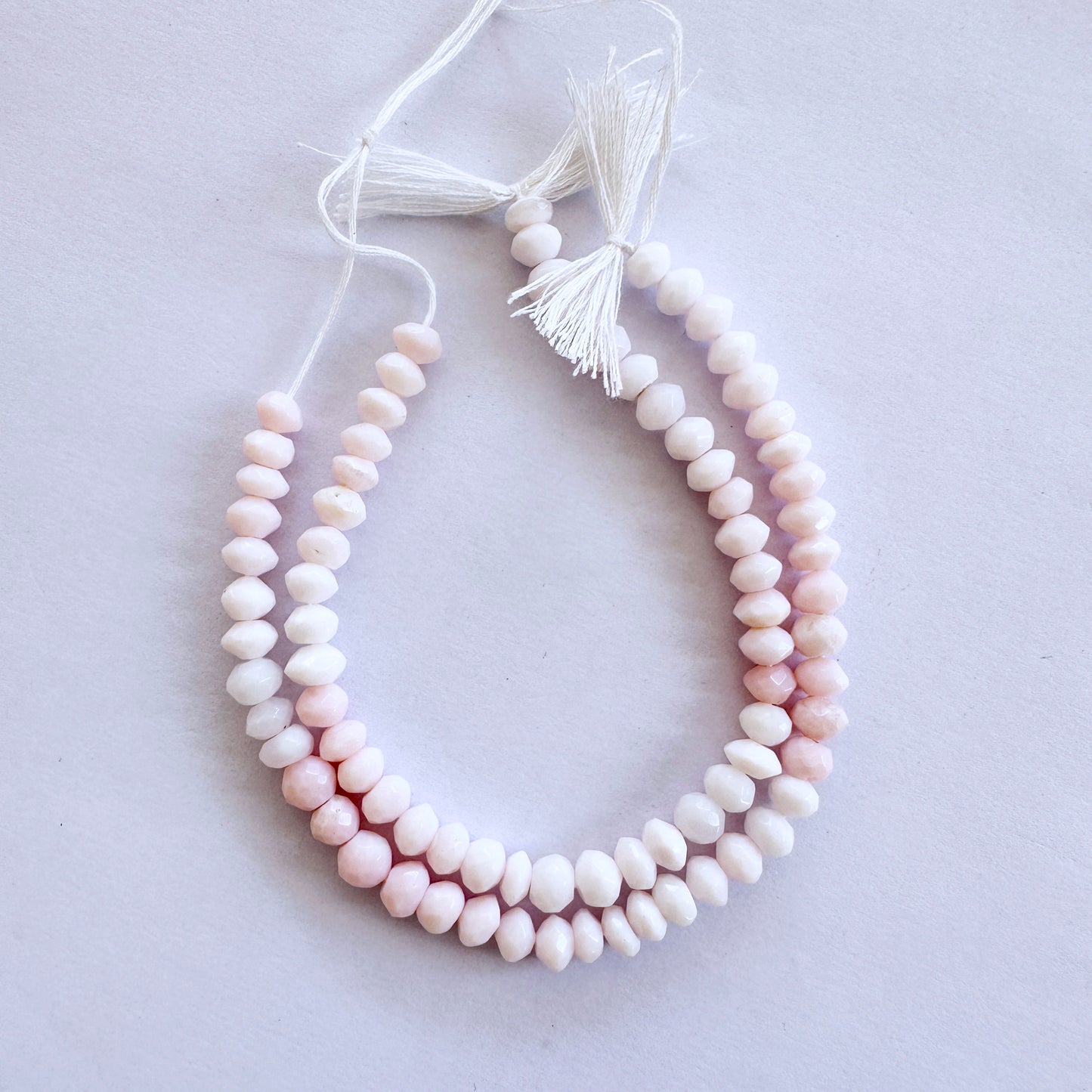 Opal faceted rondelle beads in 5.5-6mm size with soft pastel tones on a 16cm strand for elegant jewellery designs.