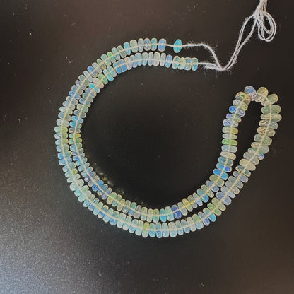 Opal faceted rondelle beads with vivid colour play and sparkling cut on a 40cm strand.