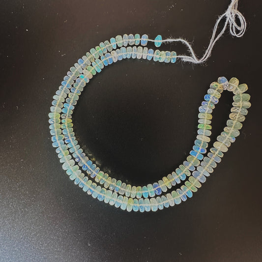Opal faceted rondelle beads with vivid colour play and sparkling cut on a 40cm strand.