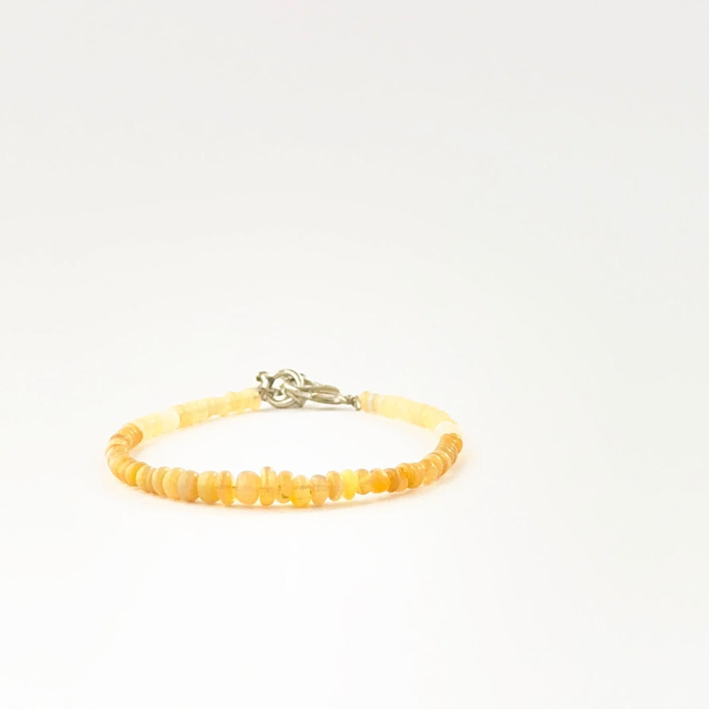 Opal bead bracelet showcasing smooth 3.4–4.7mm rondelle beads.