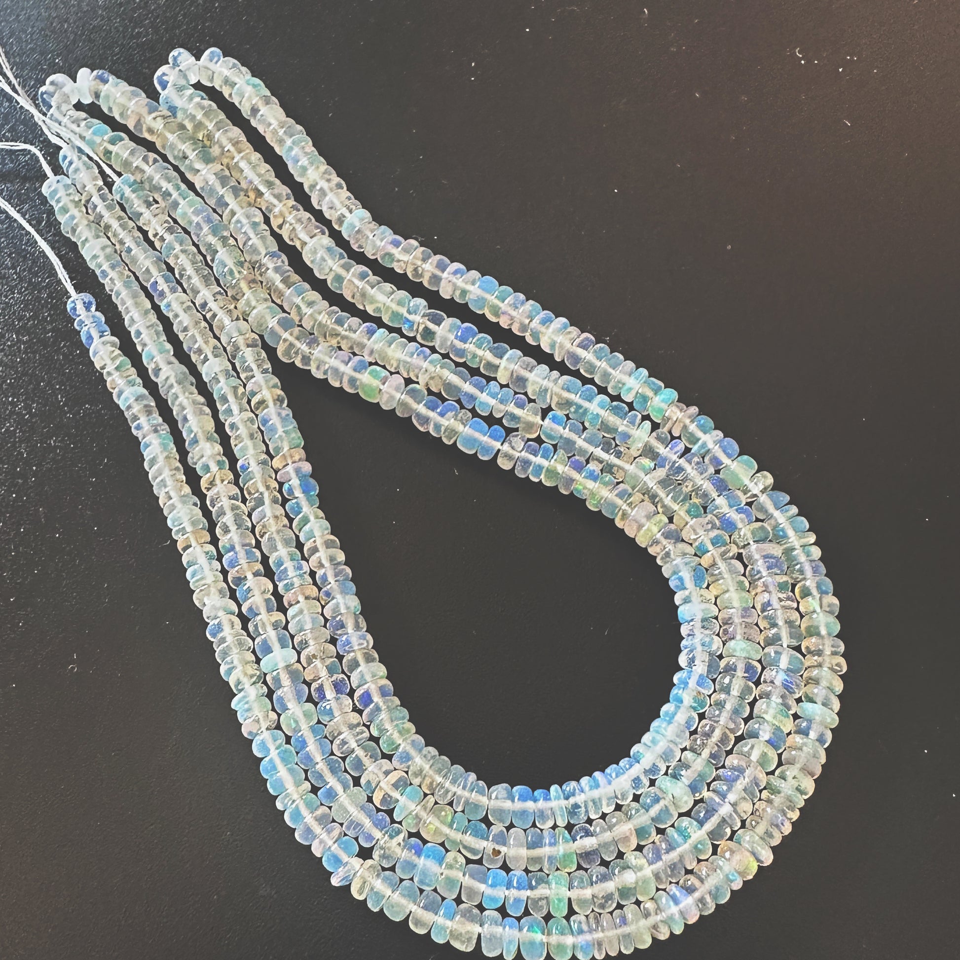 Close-up of 3.2-4.0mm Opal beads showing smooth surface and natural colour variation.