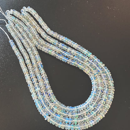 Close-up of 3.2-4.0mm Opal beads showing smooth surface and natural colour variation.