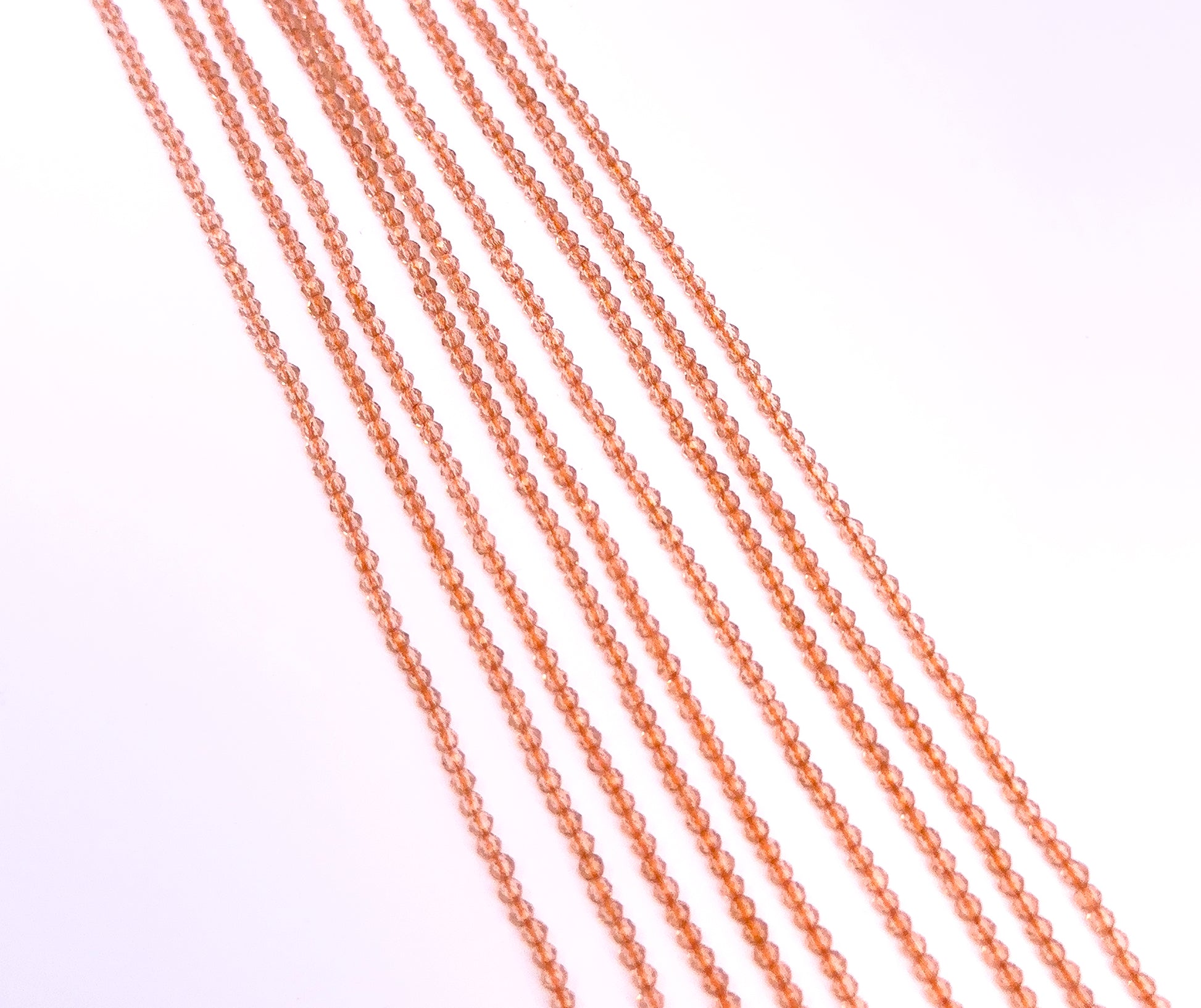 A dial gauge measures the Orange Quartz faceted rondelle 2.1mm gemstone.