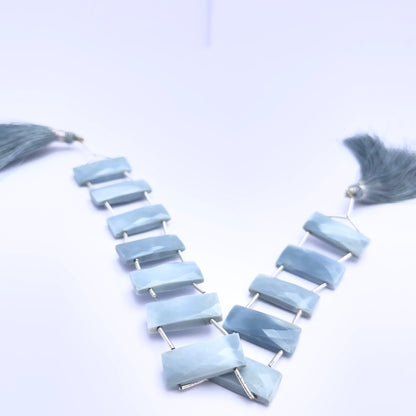 Owyhee Opal gemstone beads for jewellery making displayed with soft lighting.