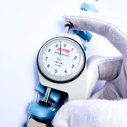 A dial gauge measures the Owyhee Opal faceted rectangle 21×9mm gemstone.