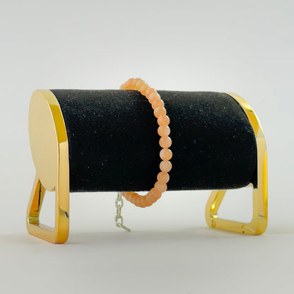 Peach moonstone bracelet showcasing 5.4mm smooth round beads.
