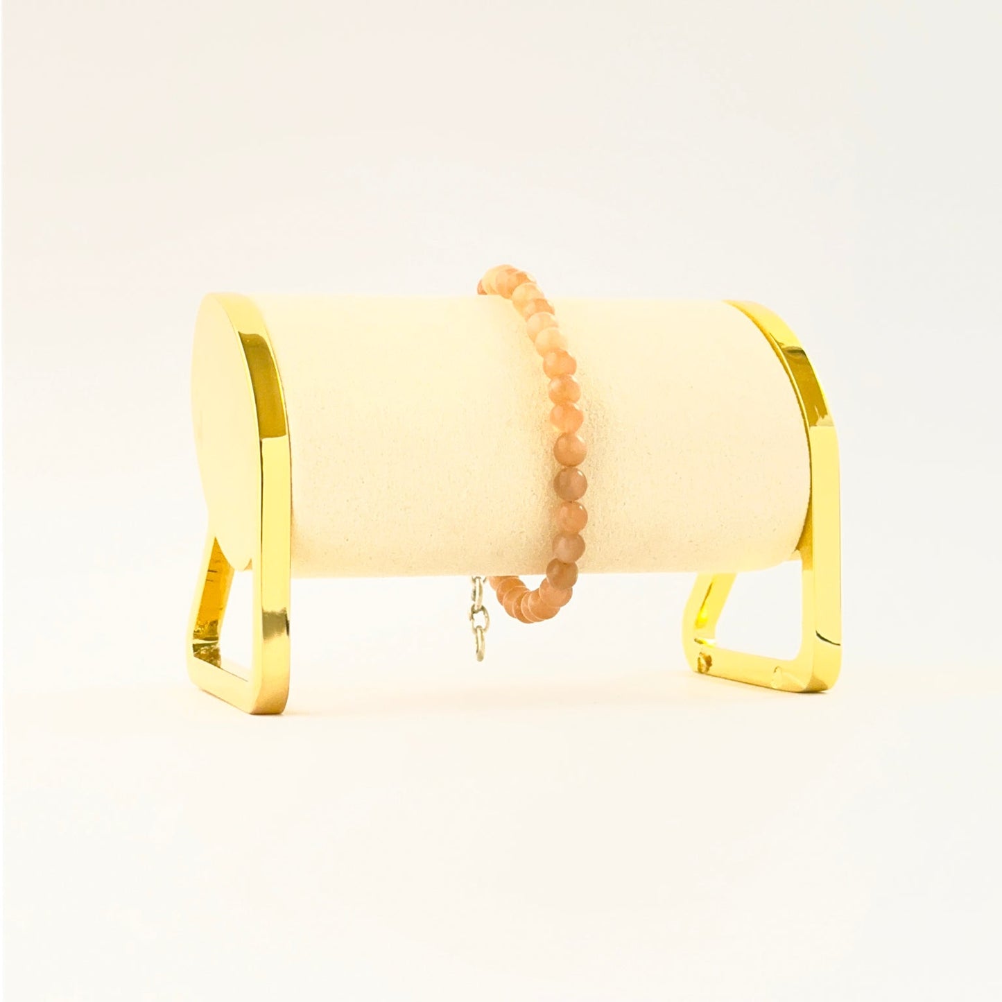 Peach moonstone bracelet featuring smooth round 5.4mm beads in an 18cm adjustable design.