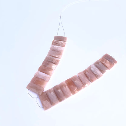 Peach Moonstone gemstone beads laid flat to highlight their rectangular shape and sparkle.
