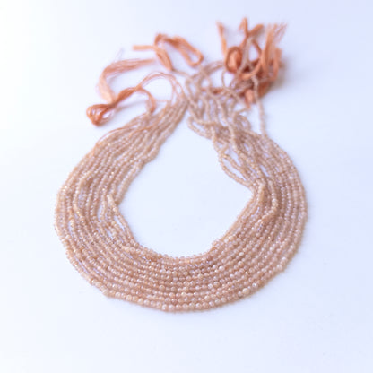 Peach Moonstone faceted rondelle beads in 2.4mm size on a 33cm strand, showcasing genuine gemstone sparkle for handmade jewellery.