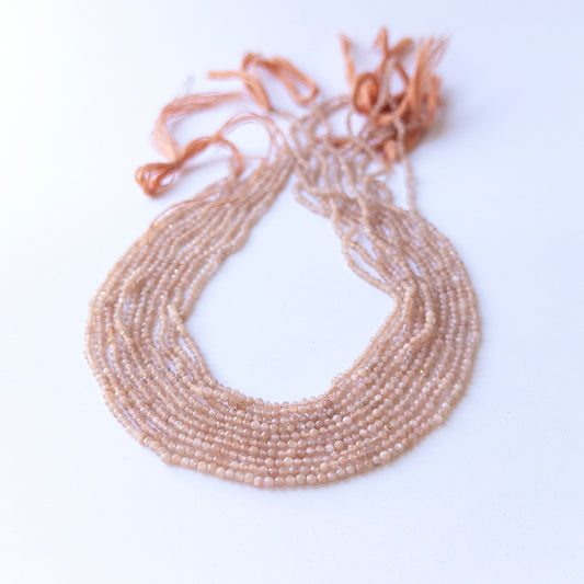 Peach Moonstone faceted rondelle beads in 2.4mm size on a 33cm strand, showcasing genuine gemstone sparkle for handmade jewellery.