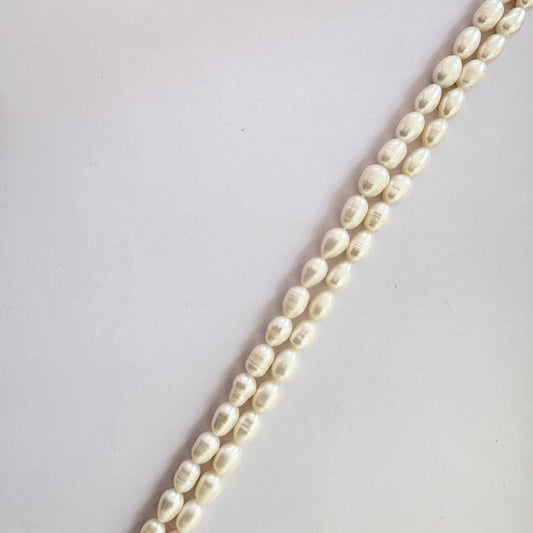Oval pearls measuring 10–11mm long and 7–7.5mm wide strung with artisanal appeal.