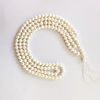Elegant natural pearls in uniform round shape shimmer with soft pearlescence.