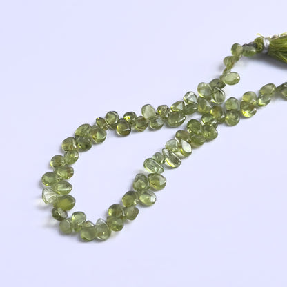 Handmade jewellery components featuring Peridot smooth drop beads strung neatly together.