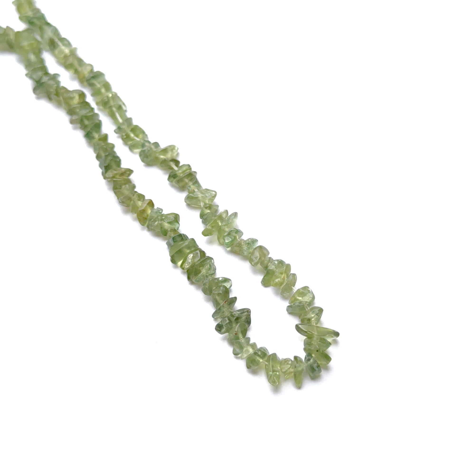 Labradorite 5.5–6mm smooth oval beads arranged on a strand, showing natural iridescence and organic shape.