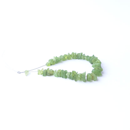 Peridot rough gemstone beads for DIY jewellery projects showing rugged surfaces and natural brilliance.
