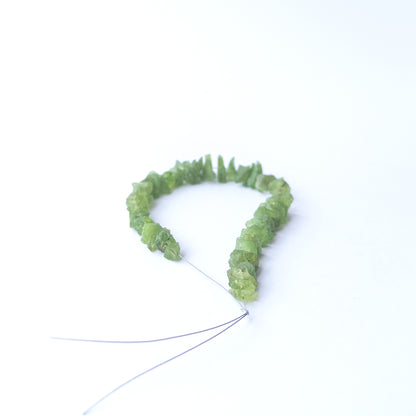 Vibrant green Peridot rough beads with drilled centres perfect for gemstone bead jewellery making.