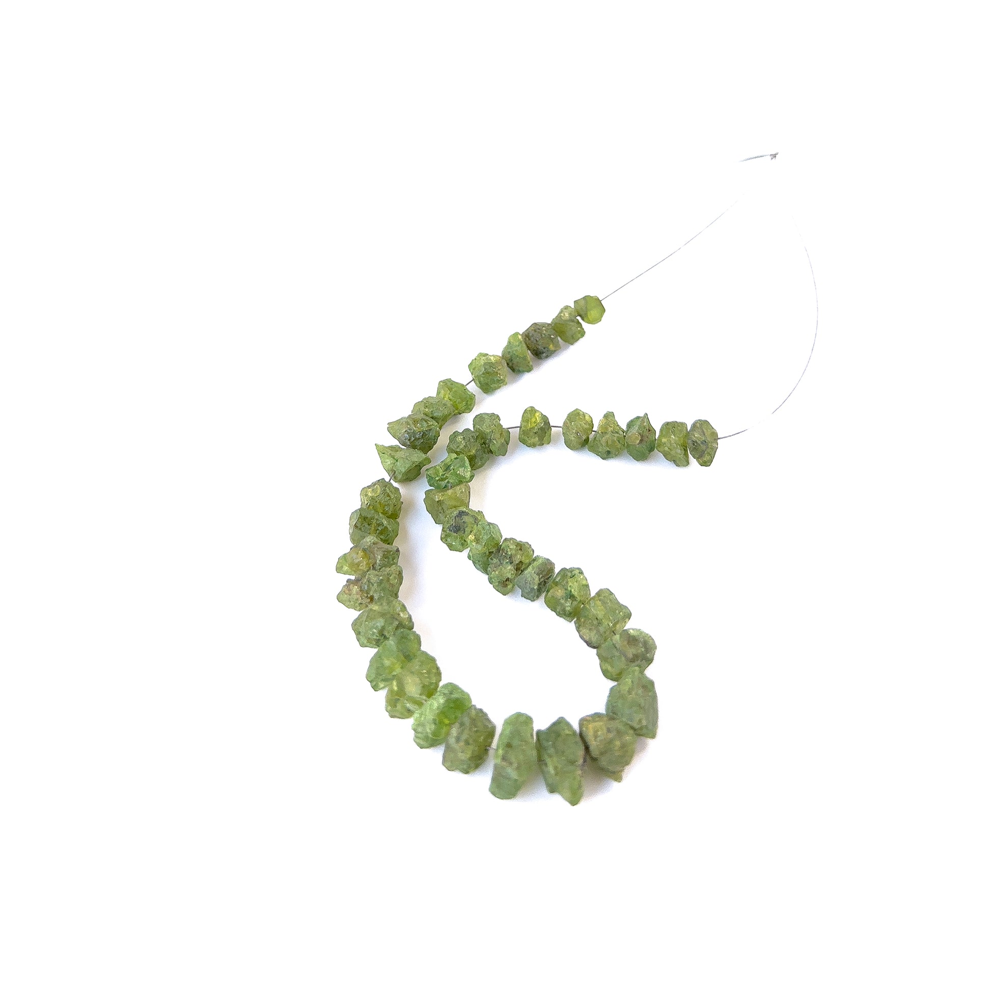 High‑quality Peridot drilled rough stones aligned on a 20cm strand for jewellery crafting projects.