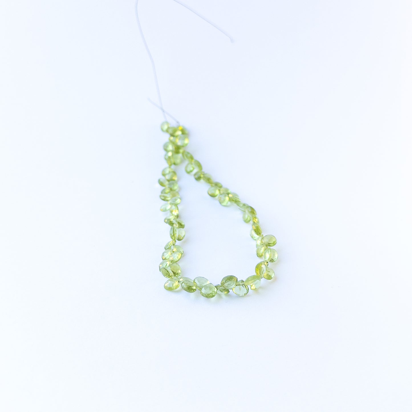 Authentic peridot gemstone beads with polished faceted briolette cuts, ideal for handmade jewellery components.