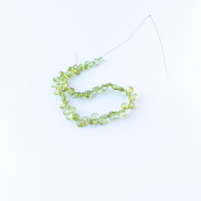 Genuine stone beads in bright green hues, featuring faceted briolettes for DIY jewellery making.