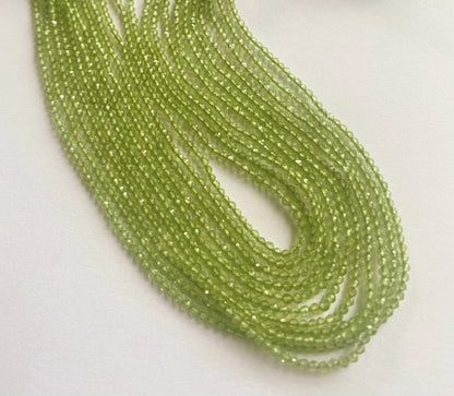 Natural Peridot beads in tiny faceted rondelles, shimmering across a fine 32cm length.