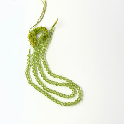 Sparkling Peridot rondelle‑cut beads with crisp shine, perfect for genuine gemstone beads in creative designs.