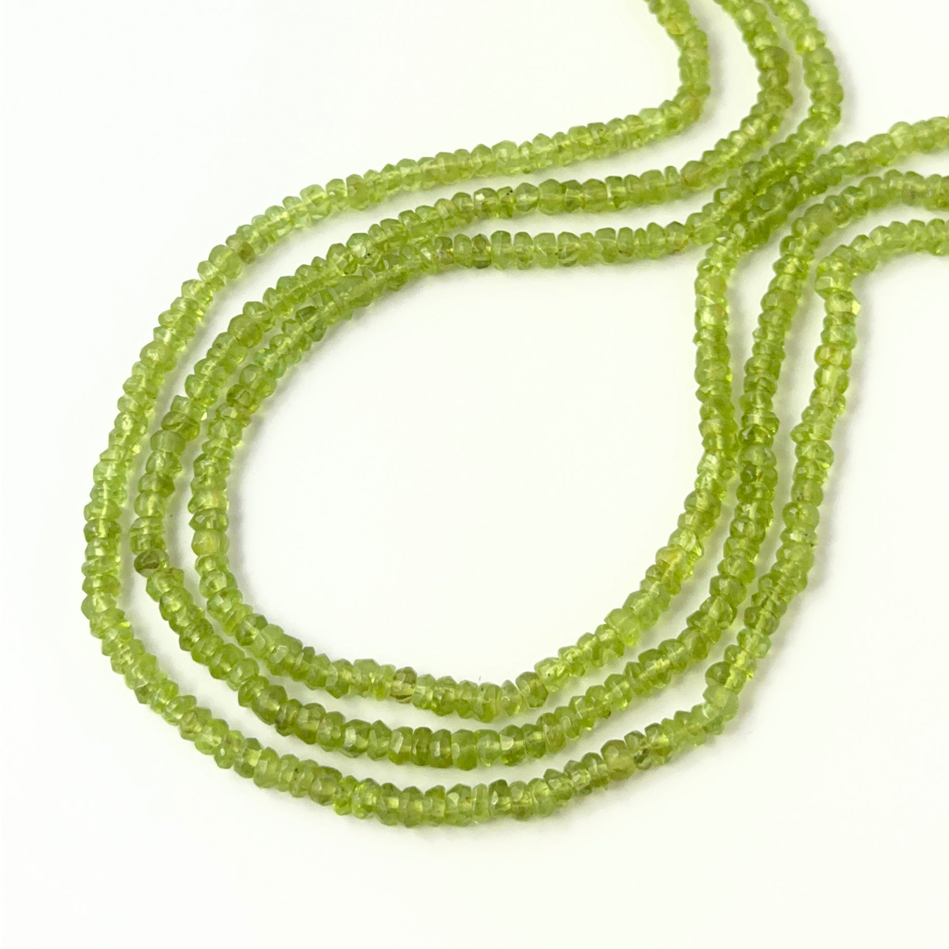 Peridot faceted rondelle beads in 3.7–4.2mm sizes on a 32cm strand, genuine gemstone beads for handmade jewellery.