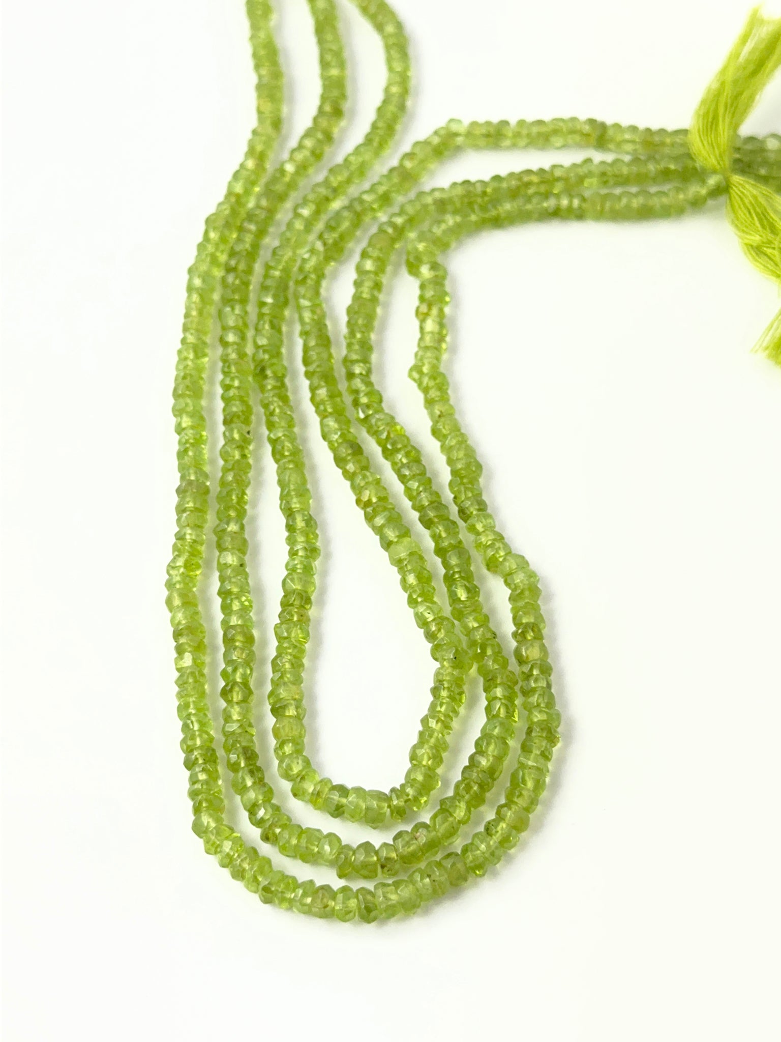 Handmade jewellery components featuring natural Peridot gemstone beads with crisp faceting and vibrant green tones.