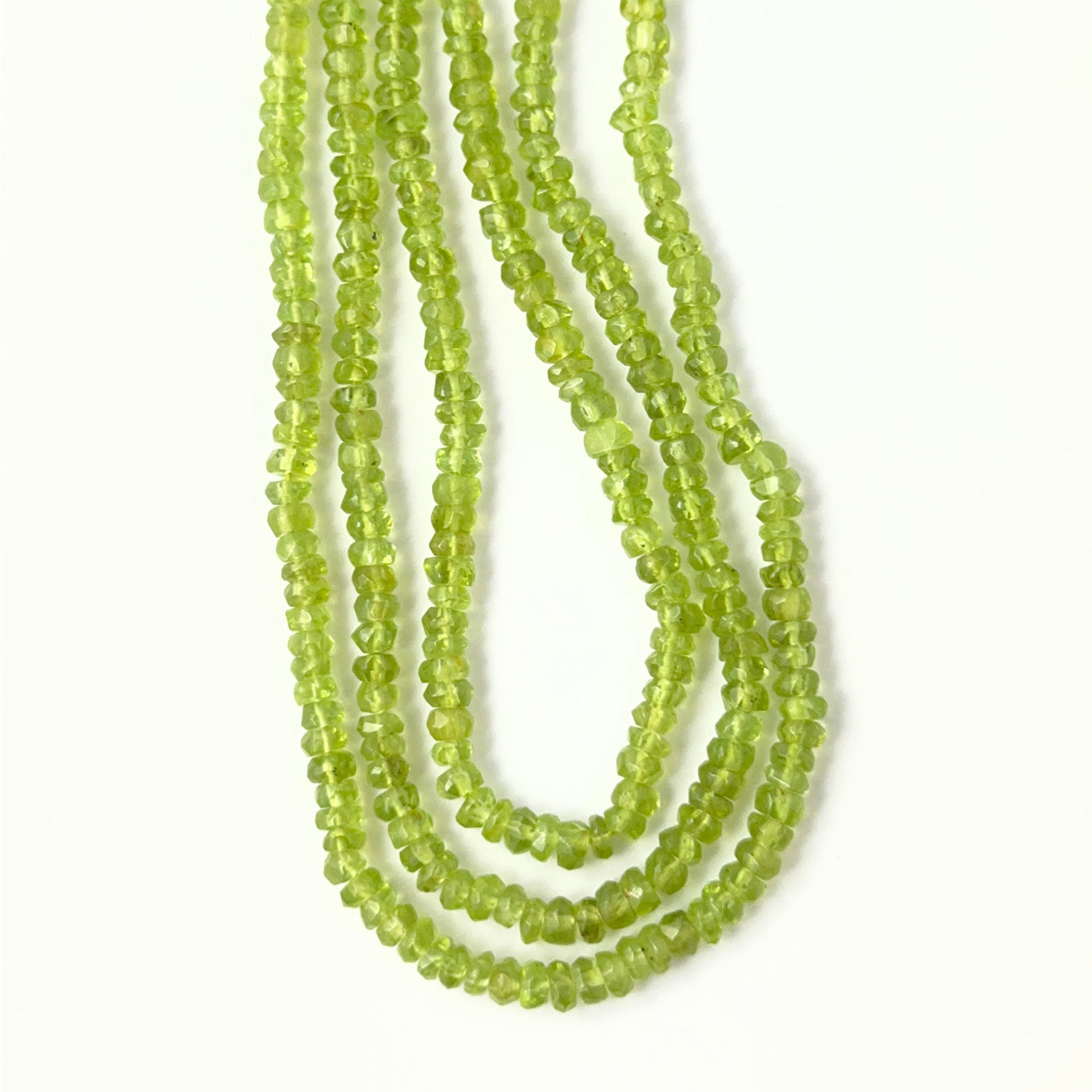 High‑quality Peridot gemstone beads for DIY jewellery, displaying a consistent rondelle cut and luminous clarity.