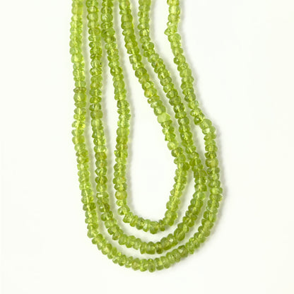 High‑quality Peridot gemstone beads for DIY jewellery, displaying a consistent rondelle cut and luminous clarity.
