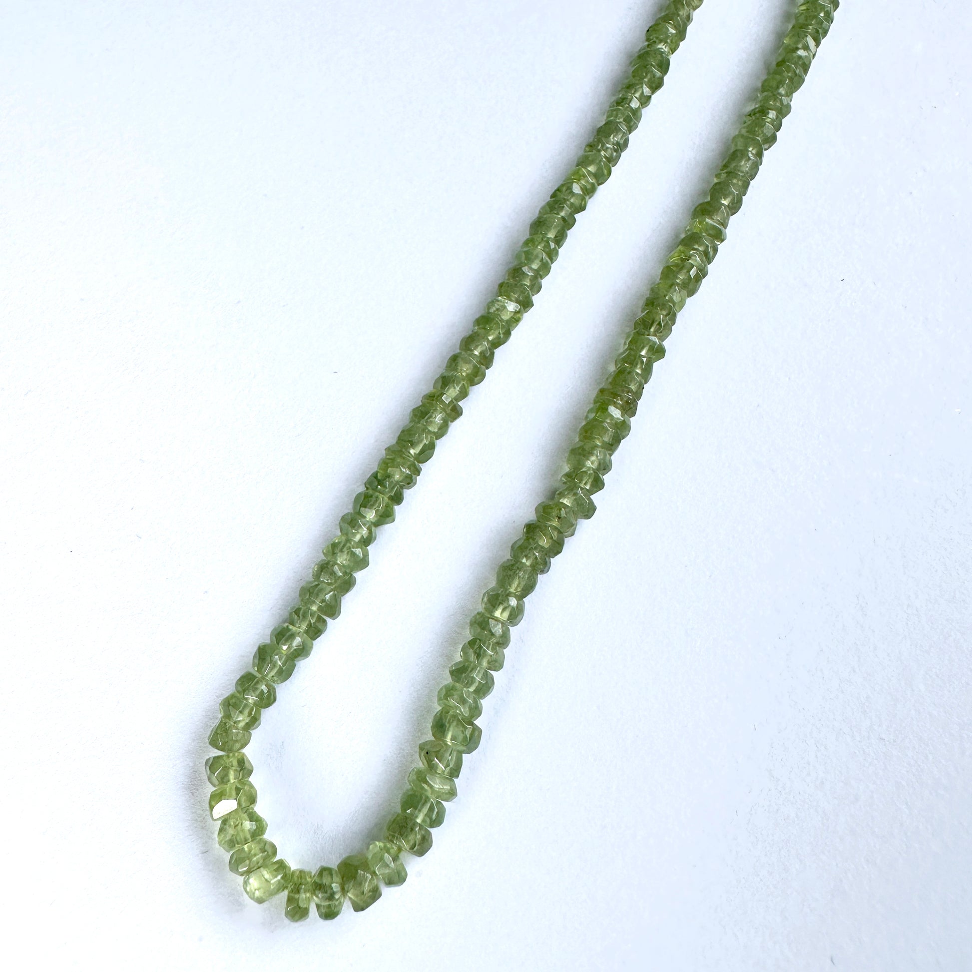 Handmade jewellery components made from 4mm Peridot beads with 0.5mm drilled holes.