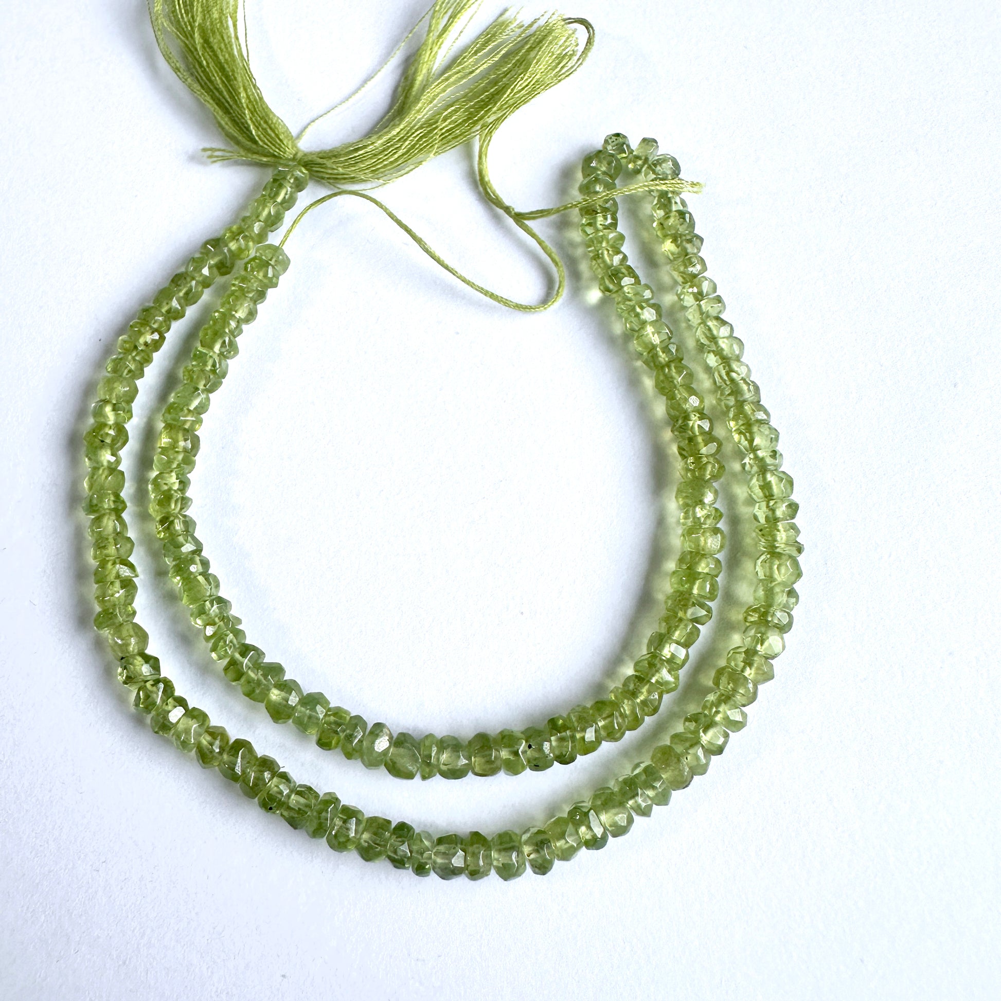 Natural gemstone beads featuring Peridot with precision faceting and vibrant green tones.