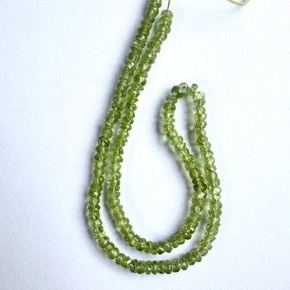 Close-up of Peridot beads showcasing their brilliant sparkle and detailed cut.