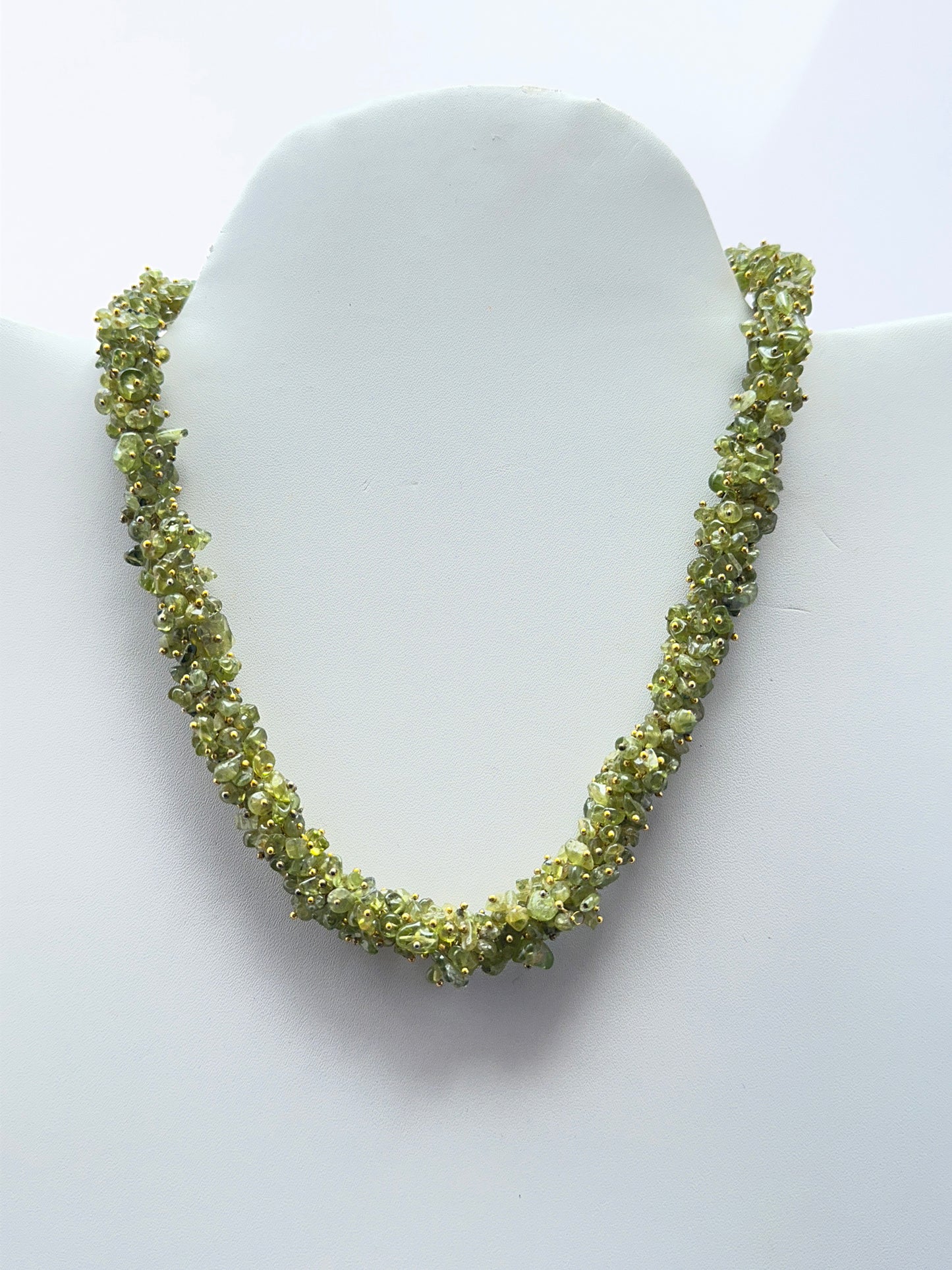 Peridot necklace featuring natural green peridot chips arranged in a vibrant design.