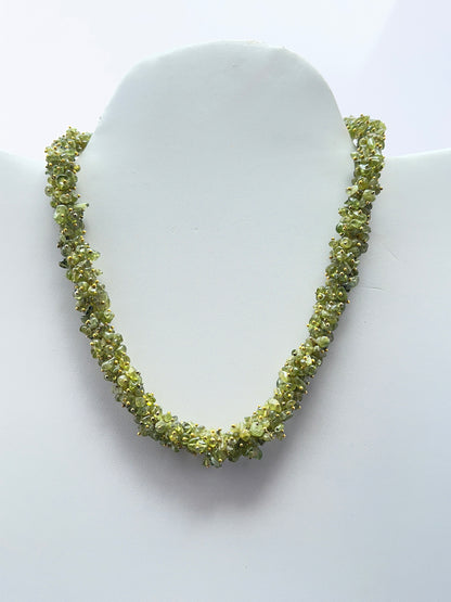Peridot necklace featuring natural green peridot chips arranged in a vibrant design.