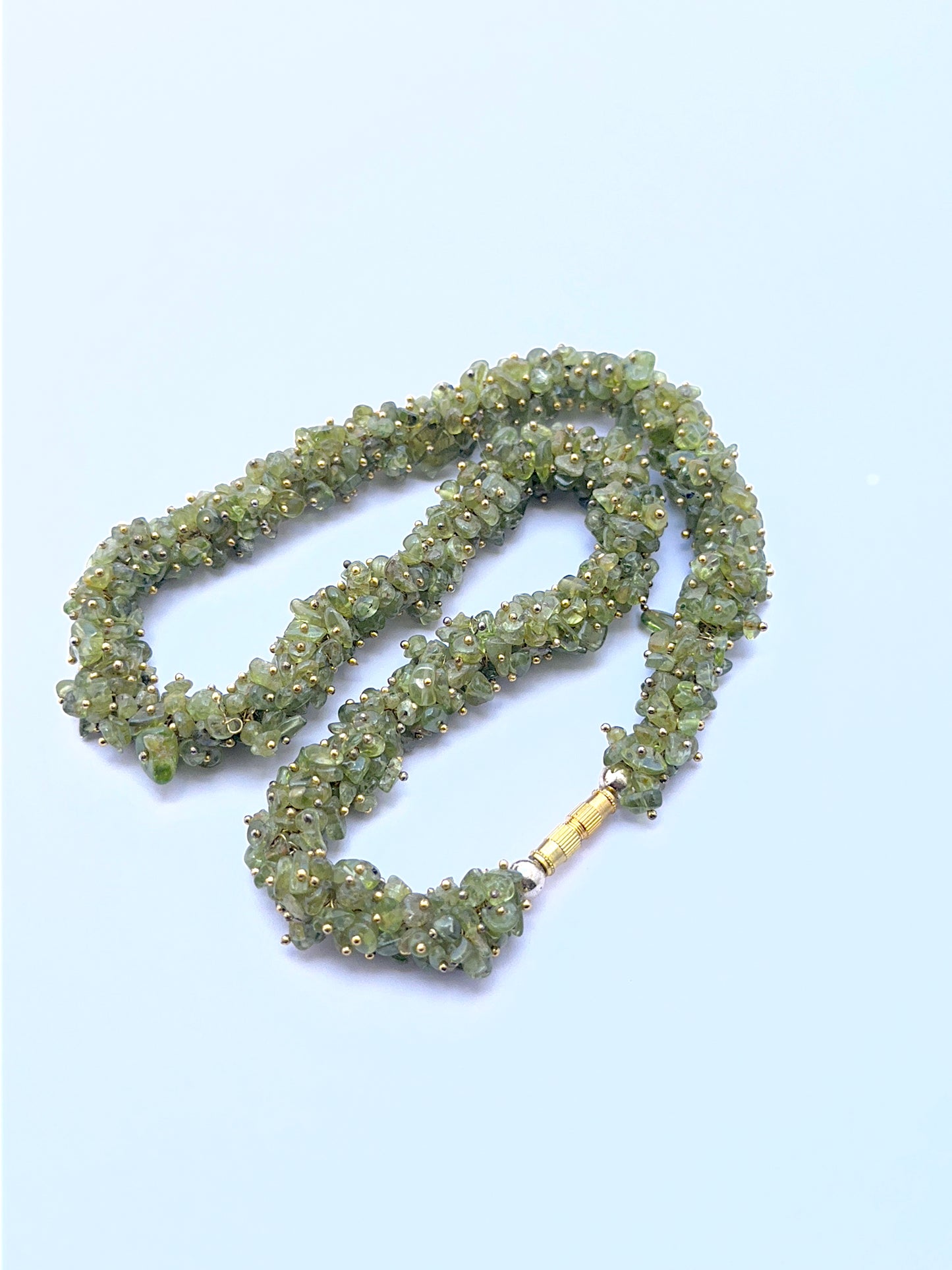 Green peridot necklace with chip beads offering natural shine and texture.