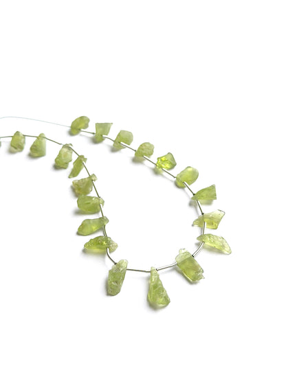 Close‑up of amethyst faceted rondelles highlighting their polished cut and natural gemstone shine.