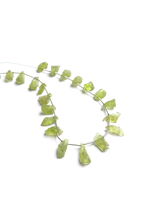 Close‑up of amethyst faceted rondelles highlighting their polished cut and natural gemstone shine.