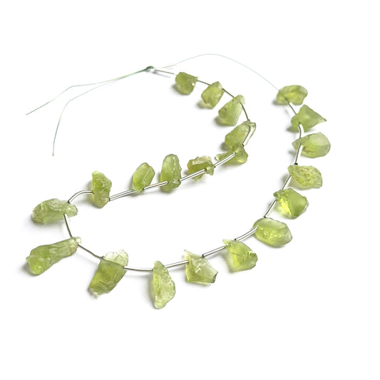 Amethyst gemstone rondelles arranged neatly to showcase clarity, colour and precision faceting.