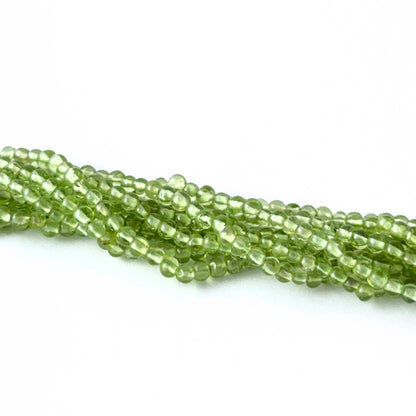Peridot smooth round gemstone beads showing fresh green tones and shine for genuine gemstone beads in DIY jewellery.
