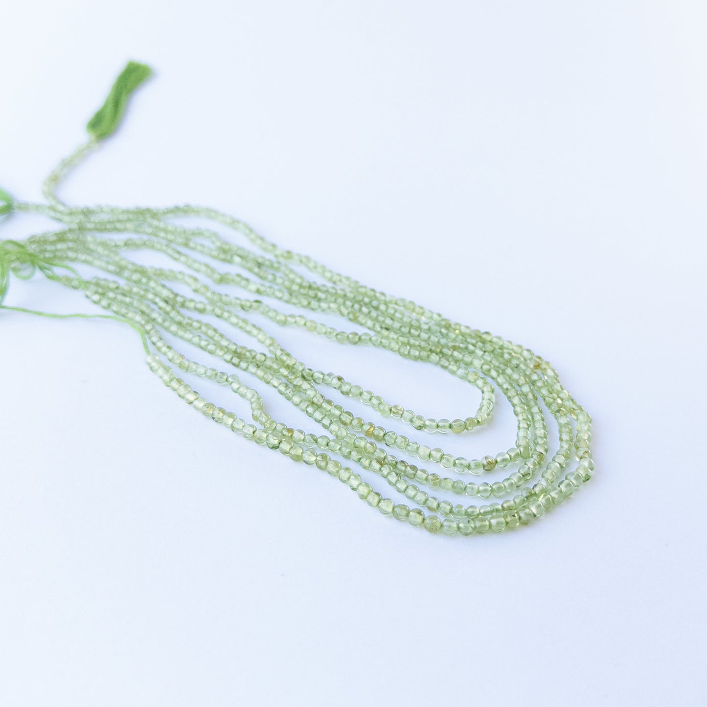 Smooth round Peridot beads with vivid green hues, perfect gemstone beads for DIY jewellery making.