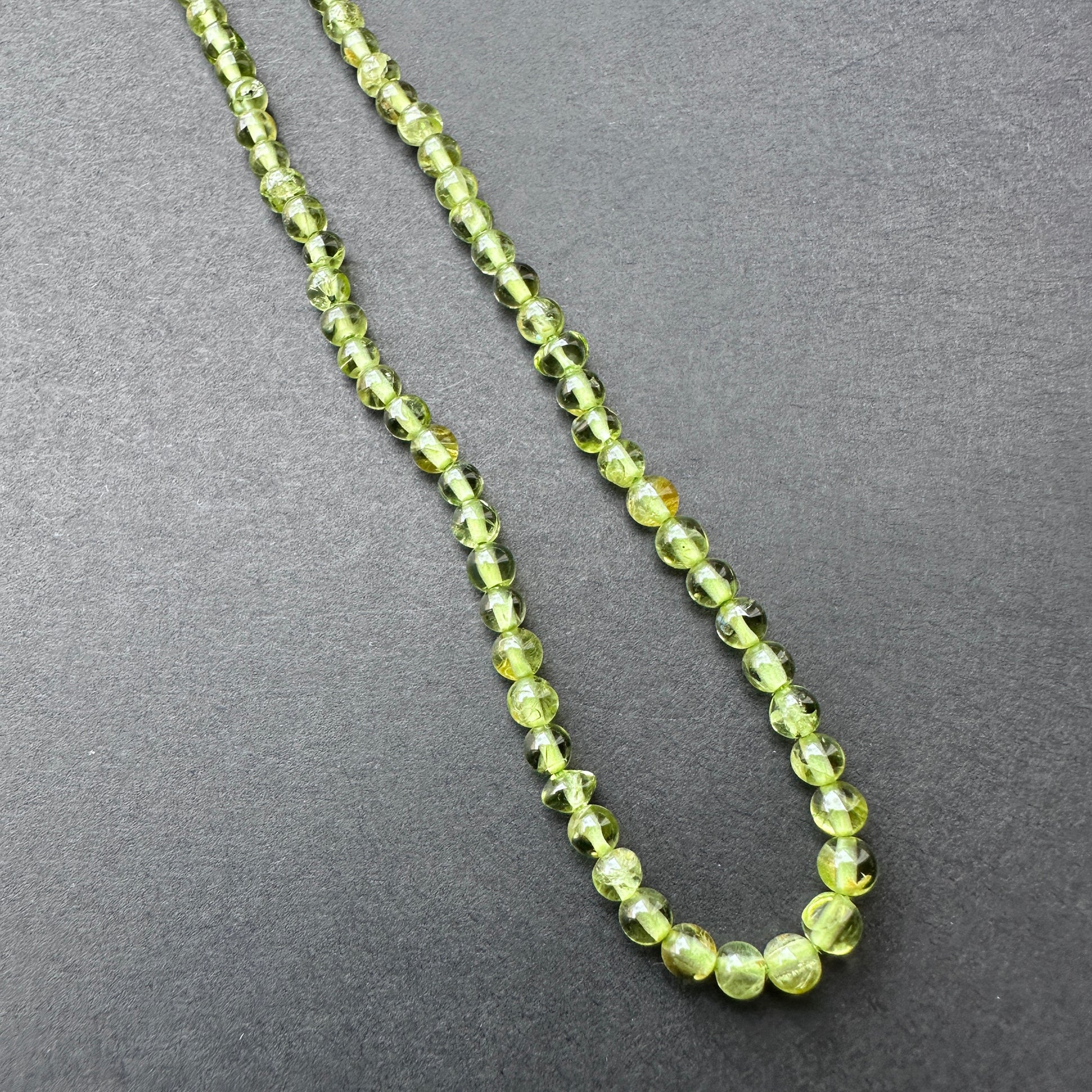 Stone Beads in Peridot with polished smooth round cut for handmade jewellery components.