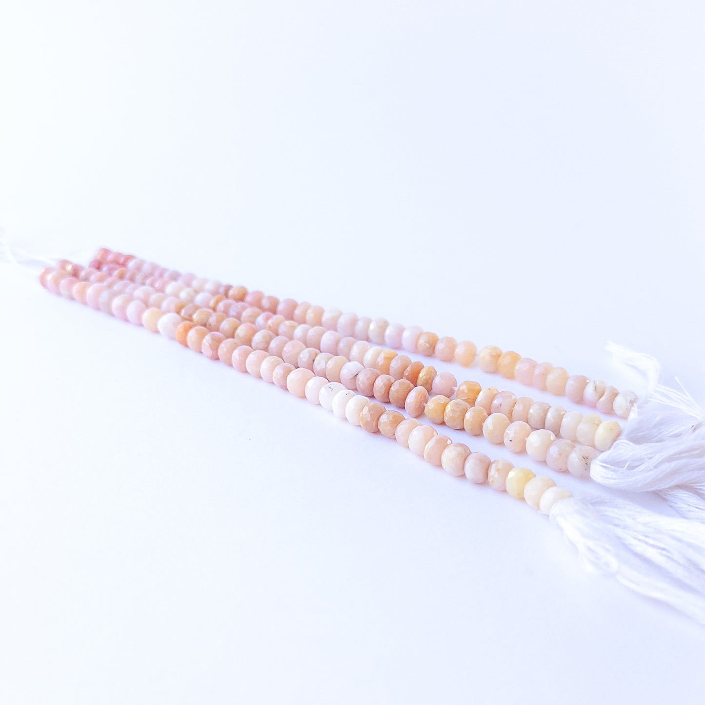 Genuine Peruvian Opal stone beads showcasing their faceted rondelle cut and soft natural shimmer.