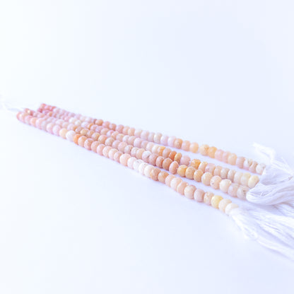 Genuine Peruvian Opal stone beads showcasing their faceted rondelle cut and soft natural shimmer.
