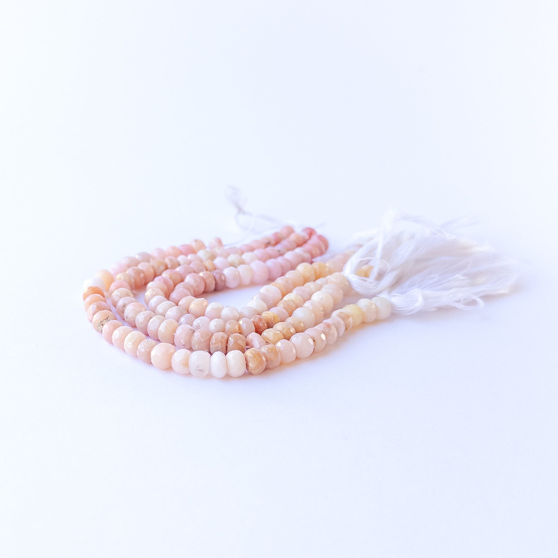 Close‑up of Peruvian Opal rondelle beads showing their sparkle, clarity, and soothing pastel tones.