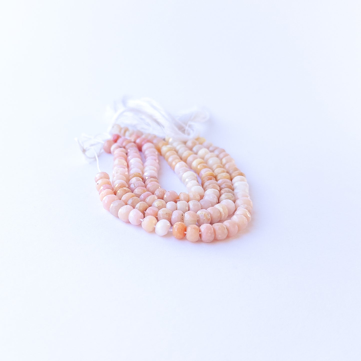Peruvian Opal faceted rondelles displaying calming hues and premium craftsmanship in a delicate strand.