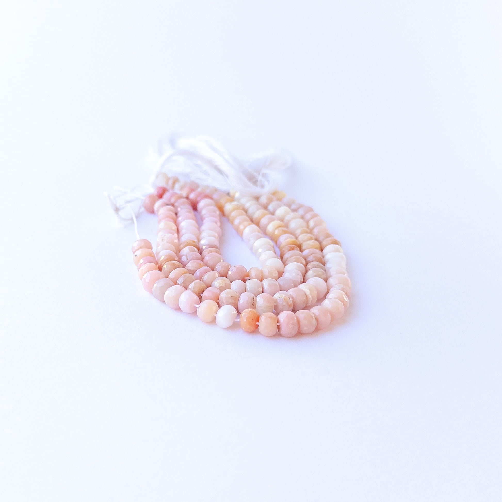 Peruvian Opal faceted rondelles displaying calming hues and premium craftsmanship in a delicate strand.