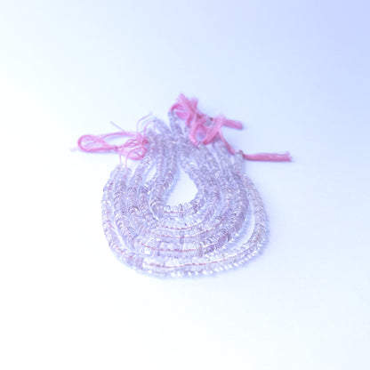 Genuine Pink Amethyst gemstone beads displaying soft lavender tones, polished surfaces, and a neatly arranged 21cm strand for jewellery design.